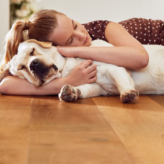 Teenage-girl-with-dog-on-wooden-floor (1)