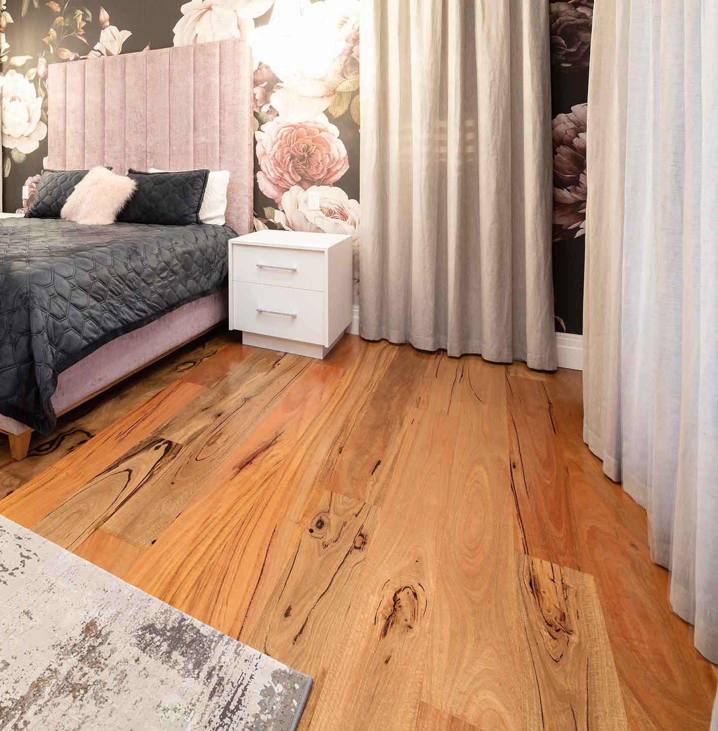 Marri timber flooring in 180mm satin boards in a Perth living room, honey and deep brown with black gum veins