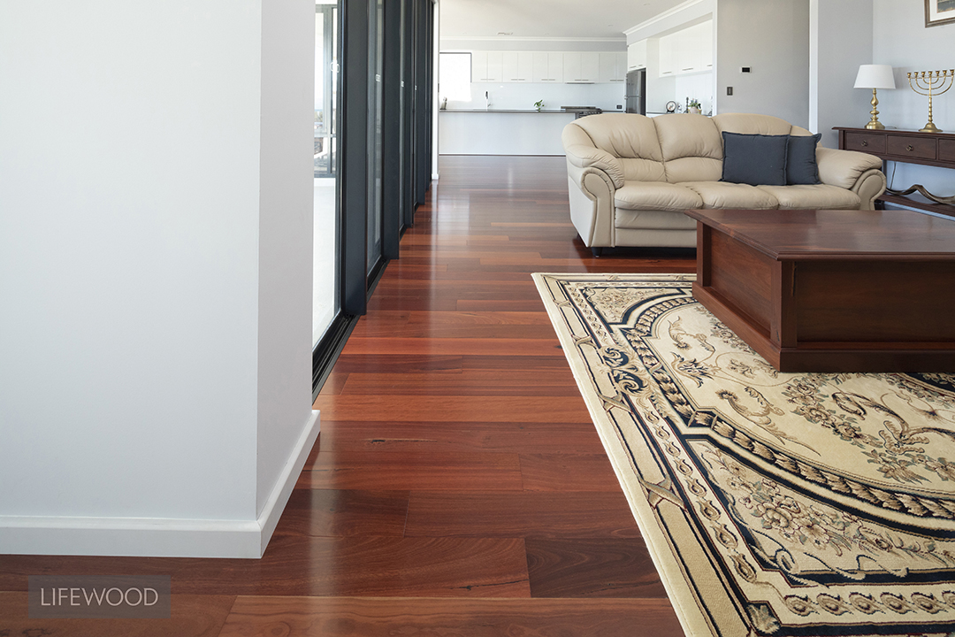 Jarrah hardwood flooring showing the deep red heartwood and black-filled gum vein characteristic of the species