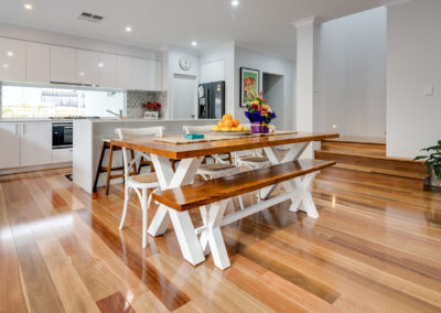 Spotted Gum timber flooring installed throughout kitchen, sunken living area with step from passageway.