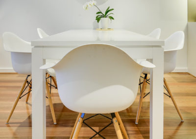 Dining table in apartment with Spotted Gum timber flooring