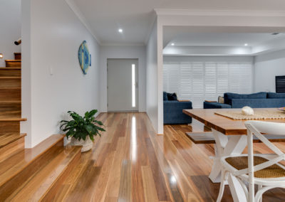 Open plan home with Spotted gum flooring in kitchen, dining and staircase