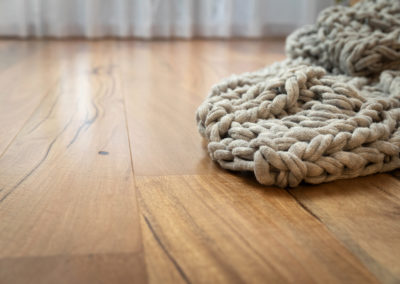 Knitted blanket laying on marri timber floor