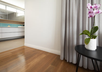 Blackbutt floor leading to the bathroom tiled area