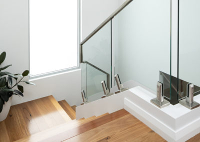 Staircase looking down from top step with Australian hardwood Blackbutt timber flooring and balustrade