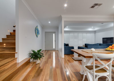 Spotted Gum timber flooring in open plan lounge room, kitchen and staircase