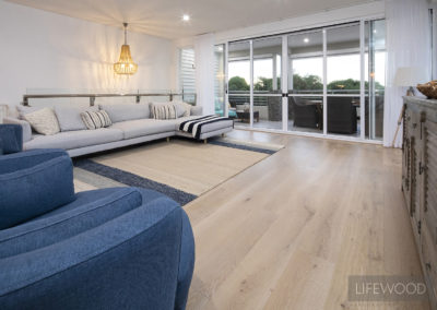 Living area attached to balcony with oak flooring