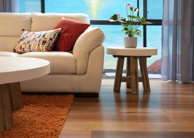 decorative interior setting with white sofa on Blackbutt wooden flooring