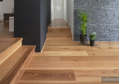 WA Blackbutt Flooring with grey stone wall