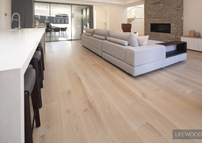 Living area with fireplace and Limed Wash French Oak timber flooring