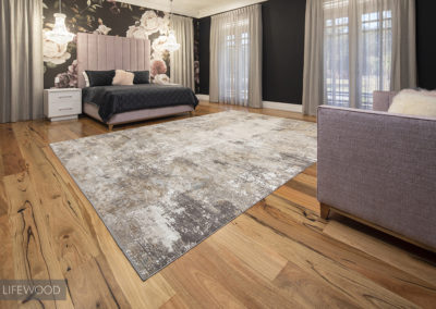Marri timber floorboards in large master bedroom with rug and big windows
