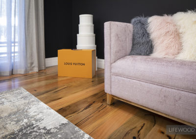 pink sofa with fluffy cushions on Lifewood timber floorboards