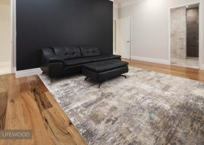 Black sofa and grey rug on marri hardwood timber flooring in Perth home
