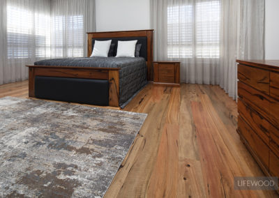 marri timber flooring in bedroom with grey rug